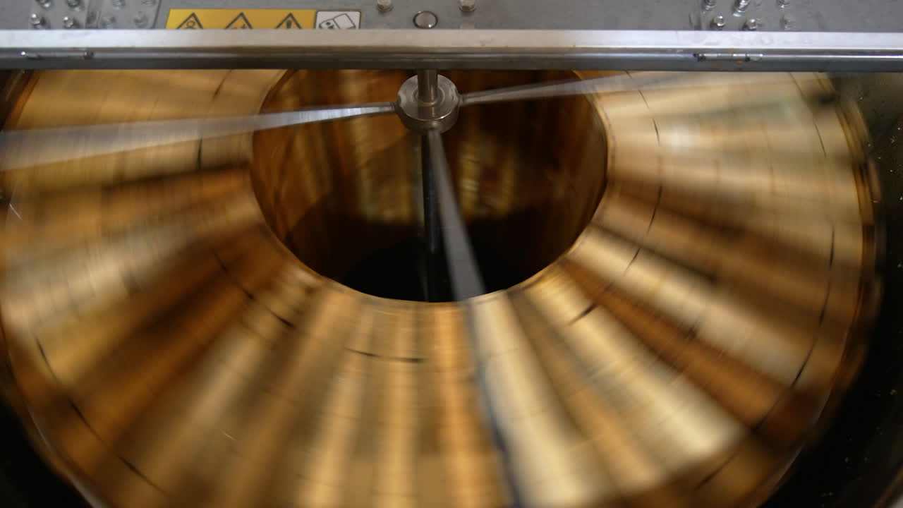 Honey frames rotated in the honey extractor machine. Close up. Top view. Apiarist's equipment for producing organic honey.