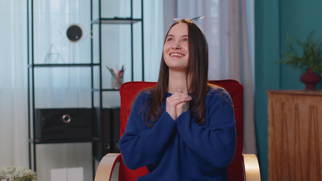 Young adult woman shouting raising fists in gesture i did it celebrating success winning at home