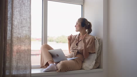 woman in headphones has fun listening to dynamic music