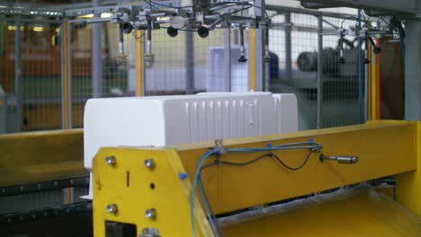 plastic container for fridge on conveyor line at refrigerator factory