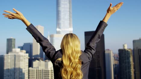 caucasian american female business manager with arms up