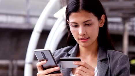 happy asian woman using cradit card for online shopping with smile. woman with shopping concept.