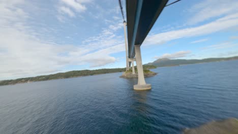 fast fpv drone flying under bomla suspension bridge and ascending over