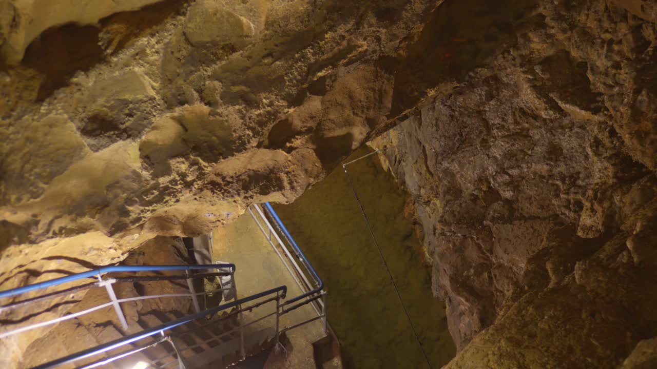 Stairs Down The Labouiche Underground River In Baulou, France. High Angle Shot