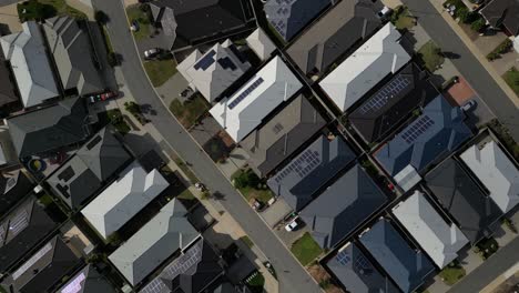 houses with solar panels on the roof, aerial top down diagonal