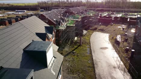 unfinished waterfront townhouse framework on development construction site aerial view