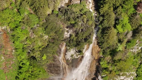 top-down aerial view of seerenbach falls cascading through lush green forest in amden, switzerland