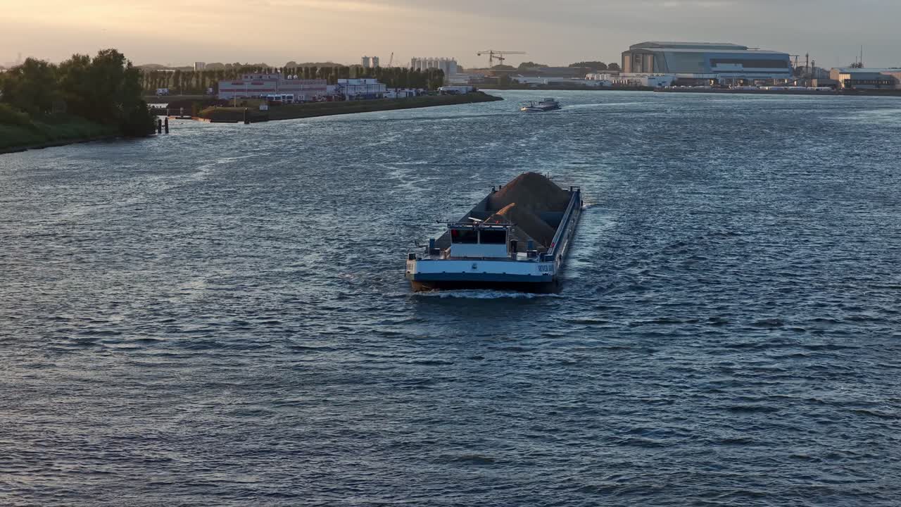 Barge on river at sunset in Dordrecht, tranquil and scenic view