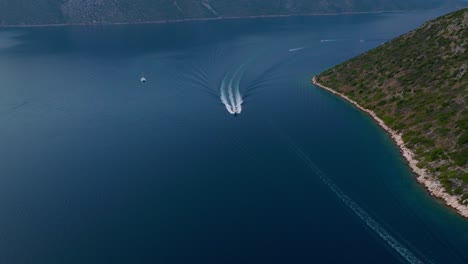 a cinematic aerial shot of a boat on the island ithaca in greece