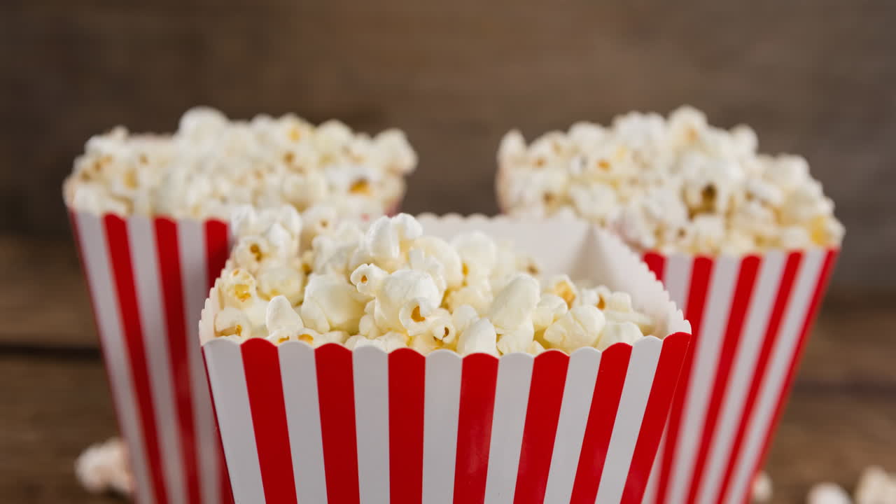 Animation of boxes of popcorn over wooden table