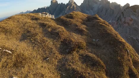 slow rise along grassy hillside cliff to witness alpenglow on the highest peaks of the dolomites
