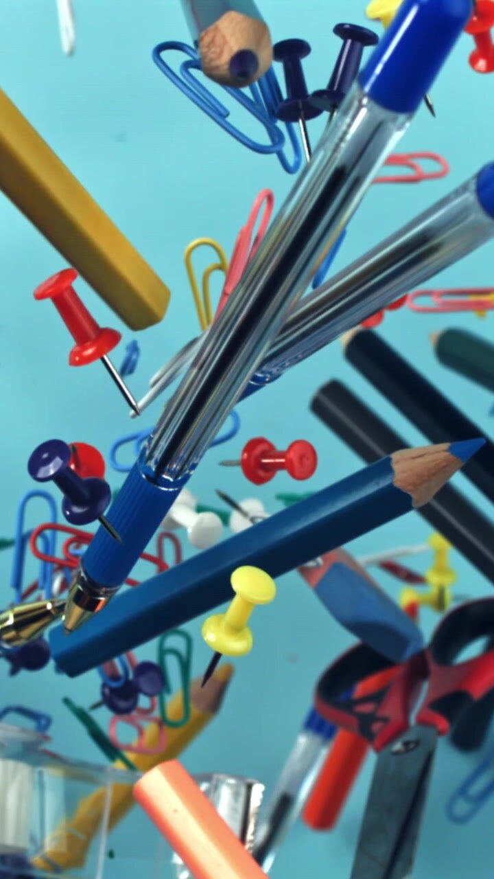 Colorful Office and School Supplies Floating Against a Blue Background