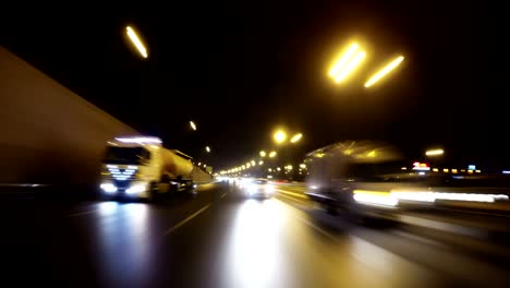 night road pov through the city at night timelapse. view of the cars behind. loopable