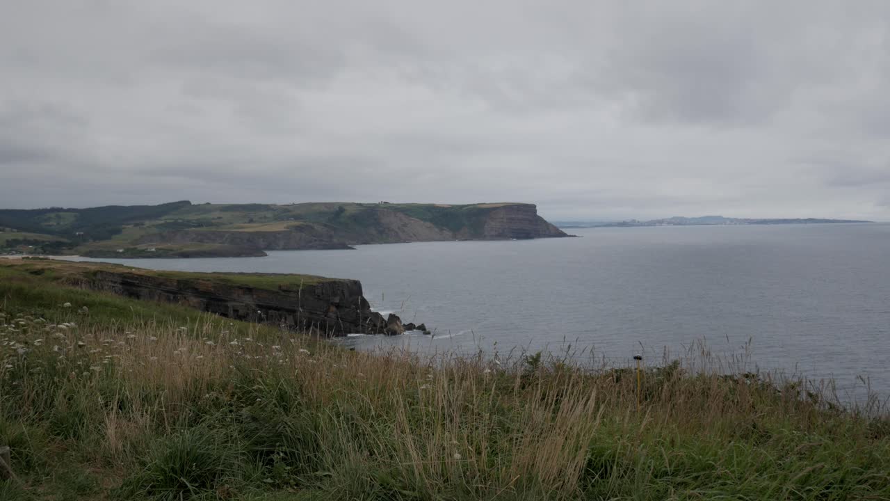 A scenic shot of the rugged coastline near Faro de Ajo, Cantabria, Spain