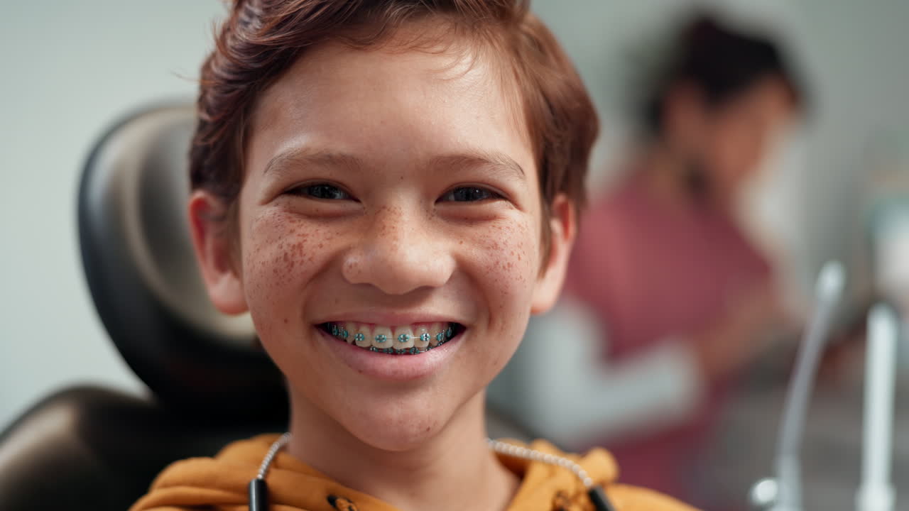 Happy Young Boy Smiling with Braces at the Dentist