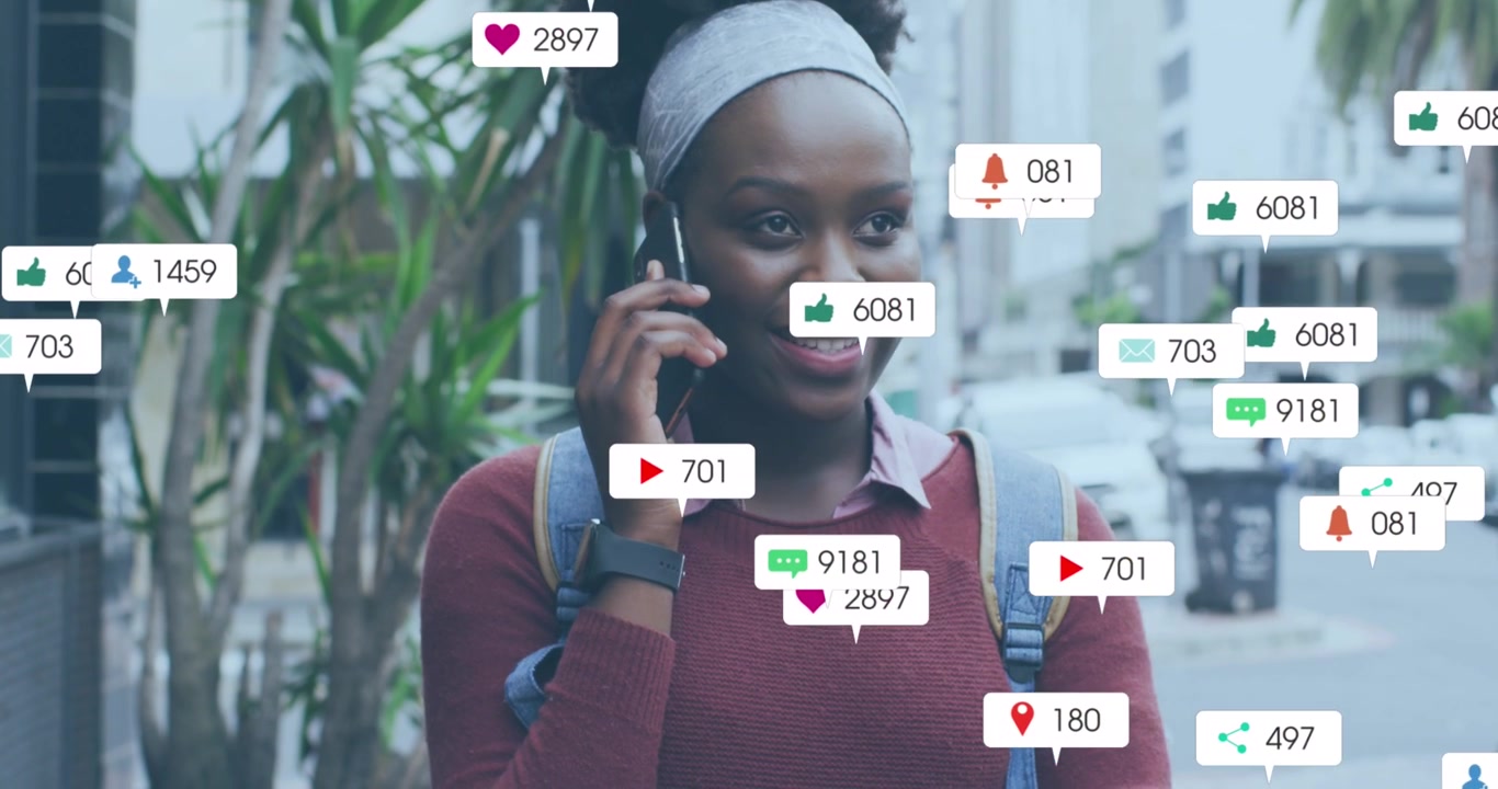 Animation of multiple social media icons over african american woman talking on smartphone outdoors