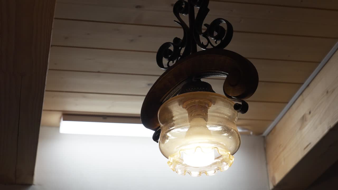 Close-up of a vintage ceiling lamp with wooden details