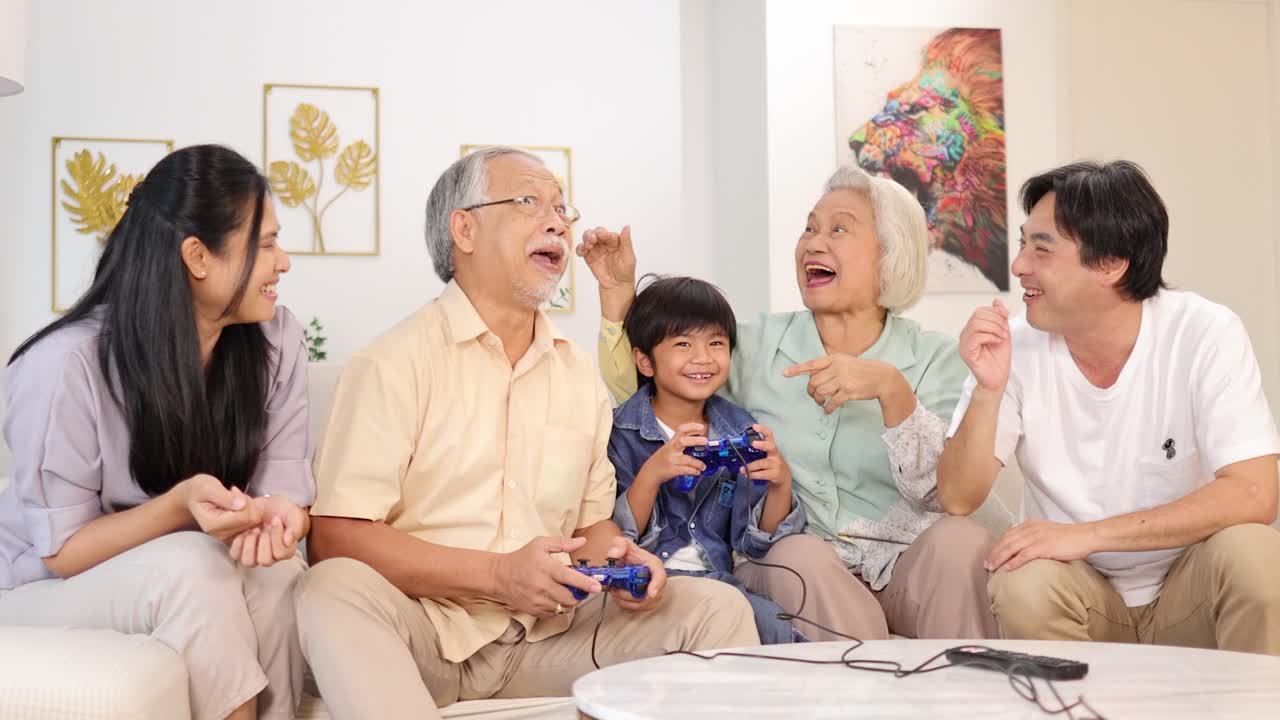 Asian family enjoying video games together on a couch, showcasing joy and connection in a bright living room setting