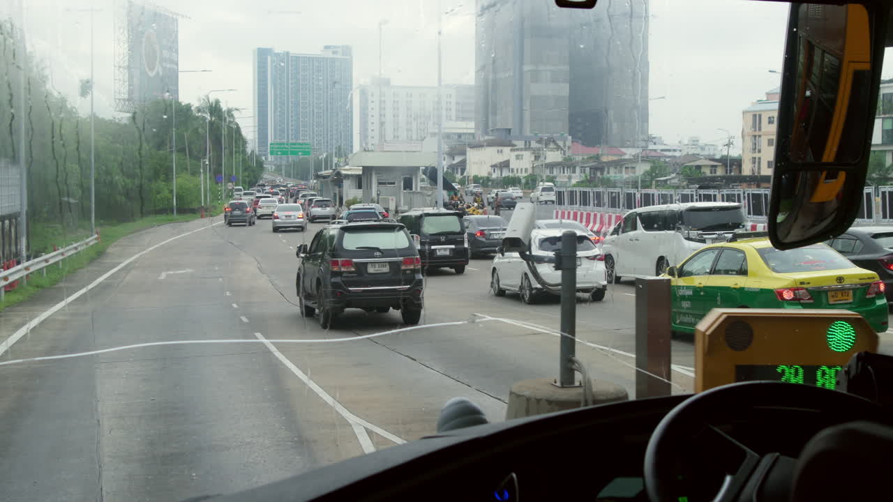 Tourist bus ride in Bangkok using the expressway with toll payment. Explore the bustling city while enjoying the efficiency and ease of expressway travel in a fast-paced urban environment.