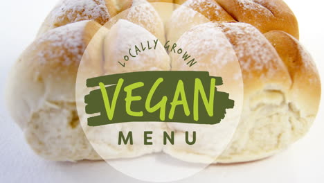 animation of locally grown vegan menu text banner against close up of fresh bread