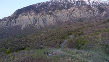 Wasatch-mountain-and-squaw-peak-road-reveal-behind-friends-relaxing-by-fire