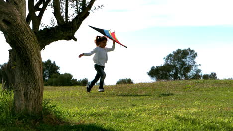 little girl running with kite