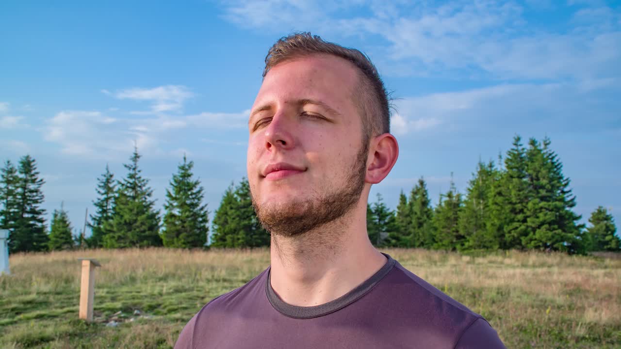 Close up dolly of happy male Caucasian with beard, Closing eyes, Enjoys moment outdoors, Mindfulness concept