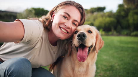 woman taking a selfie with her golden retriever in the park