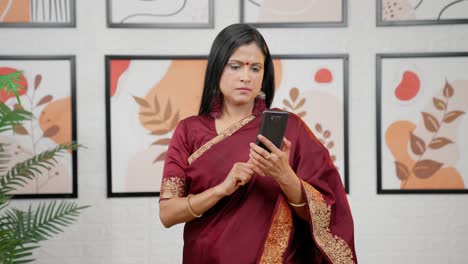 Indische-Frau-Scrollt-Zu-Hause-über-Das-Telefon