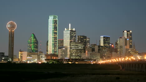 city lights illuminate the dallas skyline at night