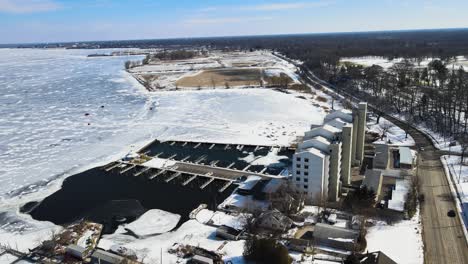 aerial tracking over an apartment building on the freezing shores of muskegon lake