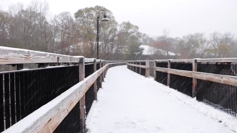 snow covered wooden bridge during fresh snowfall-1