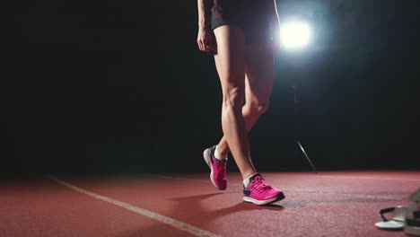 Close-up-legs-of-the-athlete-approach-the-treadmill-and-become-in-position-to-start-the-race