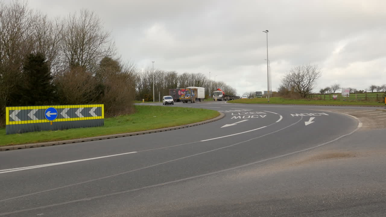 Vehicles Driving on busy Chiverton Cross Roundabout, Truro, Cornwall, UK, Wide Shot