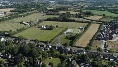 Aerial-of-Topsham-and-the-surrounding-hub-of-activity-including-community-facilities,-motorway-and-farming