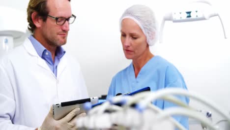 Dentist-and-dental-assistant-working-on-digital-tablet