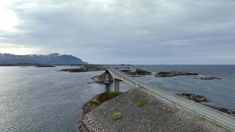 aerial flying beside storseisundet bridge, giving ful panoramic view of atlantic ocean road along coast of norway