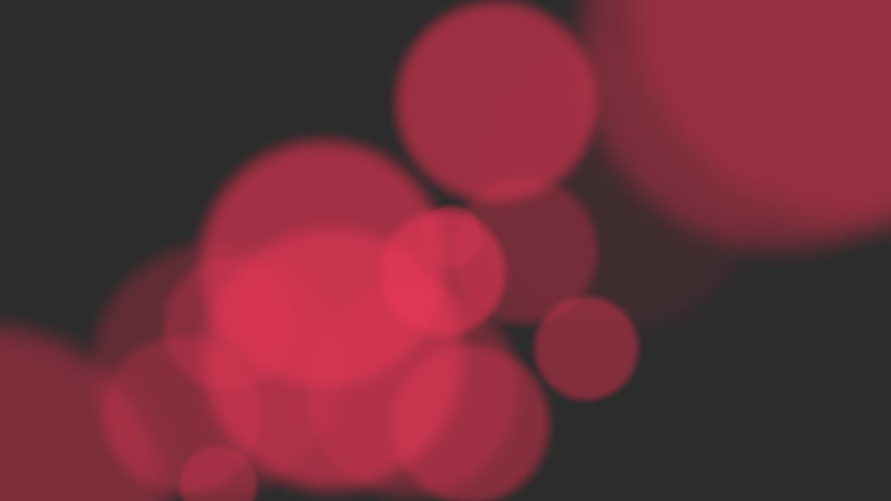 hipnotizantes círculos rojos esparcidos sobre un telón de fondo negro terciopelo