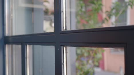 black framed window with city view