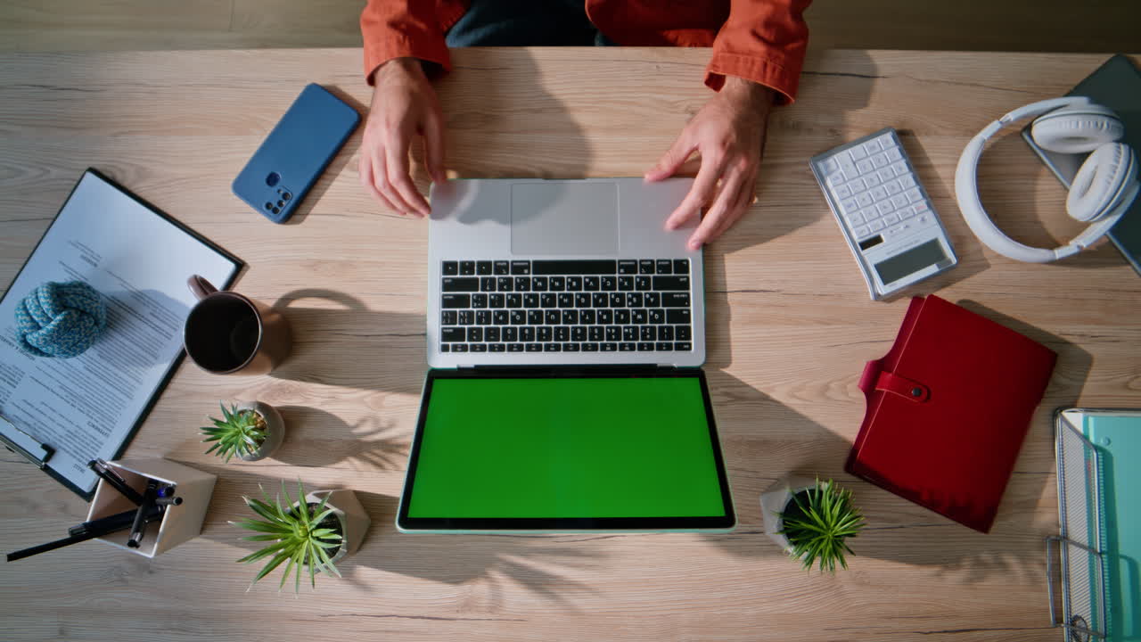Student browsing webinar green screen laptop sitting modern workplace closeup