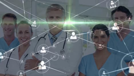 Animation-of-network-of-connections-with-icons-over-diverse-doctors