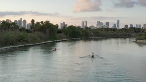 city canal at sunset with rowing and kayaking