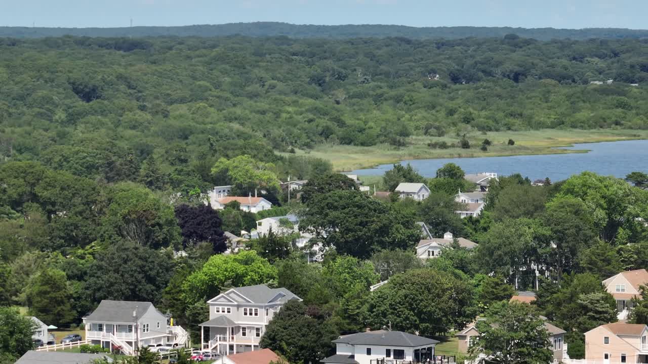 Misquamicut, Rhode Island, showing charming coastal homes nestled among lush greenery. Serene neighborhood perfect for beachside living and community vibe. Beach houses and apartments in summer
