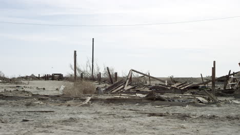 building wreckage piled on sand in desert