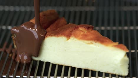 a piece of cheesecake is poured with chocolate sauce