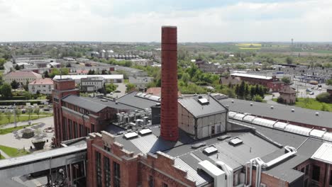 aerial orbit shot of the chimney in arche hotel żnin inside old sugar factory in poland