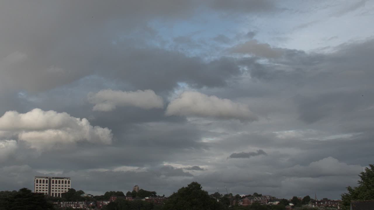Cloudy cityscape with buildings and trees