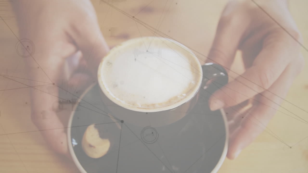 Latte foam cup being animated in 3D render, showing hands holding it beside broken biscuit