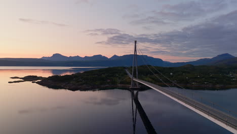 sunset drone flight next to iconic halogaland bridge in narvik, norway