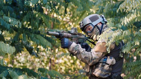 an airsoft player is hiding in a thicket of trees